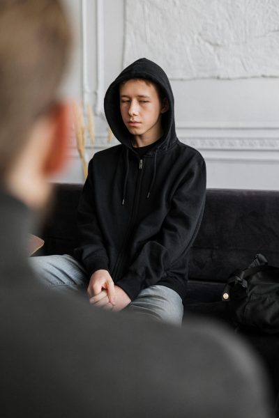 pexels-cottonbro-white young man sitting with a counselor